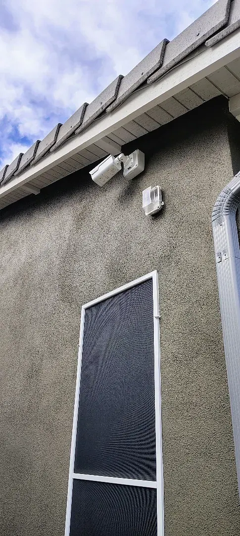 Close-up of an exterior security camera and its wall mount