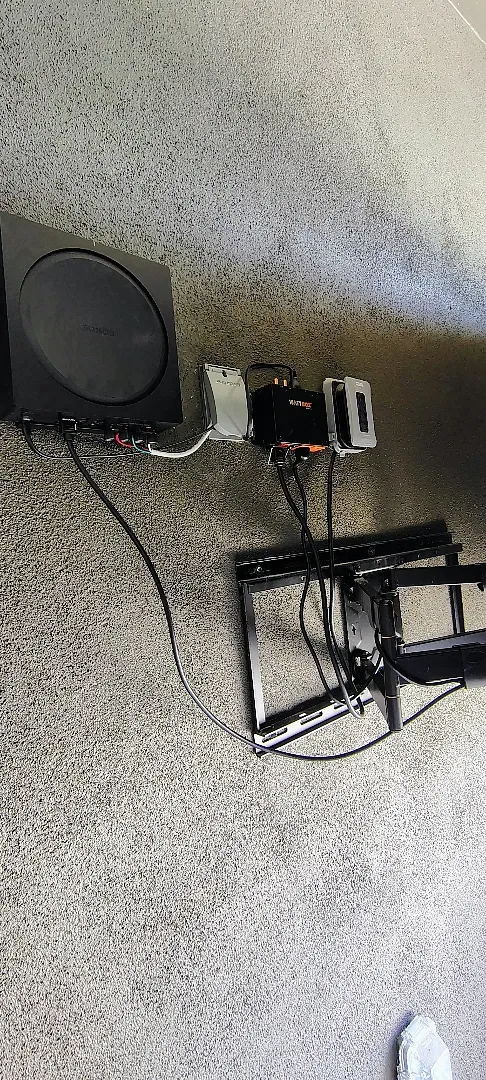 Sonos Amp, WattBox power protection and mounting equipment behind the patio TV